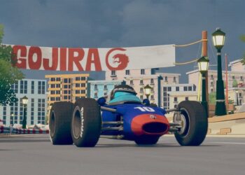Formula 1 car with a cartoon racer rides under a banner that reads "Gojira".